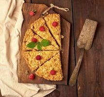 sliced triangular pieces of crumble pie with apples photo