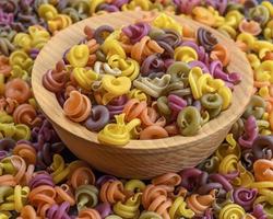 multicolored spiral raw pasta fusilli photo
