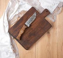 empty old wooden kitchen cutting board and knife photo