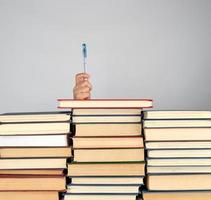 stack of different books on a gray background photo