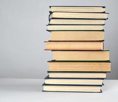 stack of different books on a gray background photo