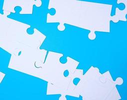 empty white big puzzles on a blue background photo