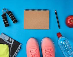 open empty notebook and sports women's clothing for sports and fitness photo