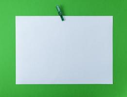 white blank drawing sheet on green plastic clothespin photo