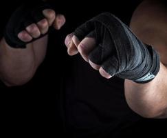 two men's hands rewound with a black textile band photo