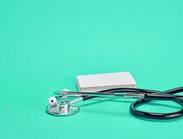 medical stethoscope and empty paper business cards photo