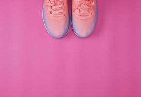 pair of  pink sneakers with  laces photo