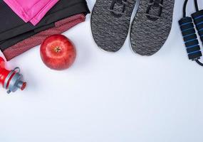 black textile shoes and other items for fitness on a white background photo