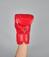 raised up hand in red boxing glove photo