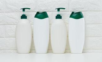 Empty plastic white bottles for cosmetics and other liquid substances on a white background. photo