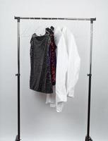 black women's blouse with red sequins, white men's shirts hang on a white iron hanger photo