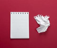 notebook with white sheets and a crumpled  sheet of paper photo