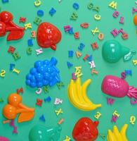 green background with childrens plastic toys photo