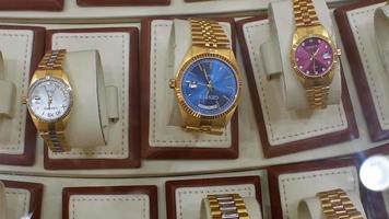 Dubai, UAE, 2022 - unique golden Geneva brand watches in shop on display in Gold soak. Shopping gold UAE video