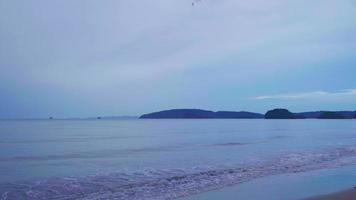 the sea and the sandy beach in the evening on a rainy day See the mountain range as a distant label, Ao Nang Beach, Krabi Province video