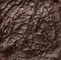 texture of baked brownie chocolate cake with chocolate poured photo