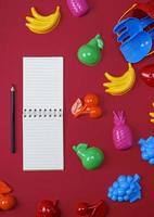 notebook with empty white sheets and black wooden pencils photo