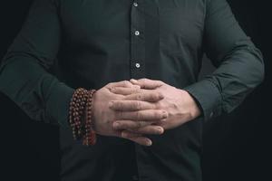 man in a black shirt crossed his arms in front of the torso photo