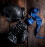 pair of very old black leather boxing gloves photo