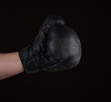 hand in black leather boxing glove photo