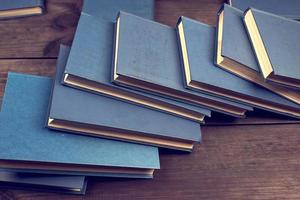 books in a blue cover on a brown wooden table photo