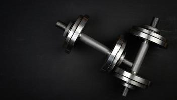 pair of shiny steel typesetting dumbbells for bodybuilding photo