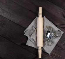 wooden rolling pin and iron bakeware photo