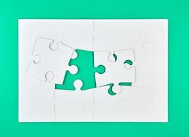 big paper puzzles on a green background photo