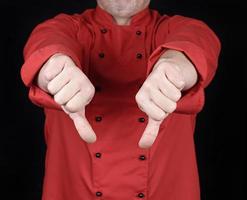 cook in red uniform  shows gesture dislike with hands photo