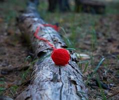 unwound small red ball of wool yarn photo