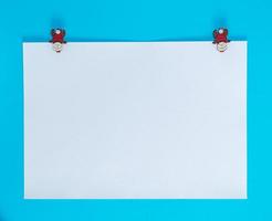 white square sheet of paper on a blue background photo