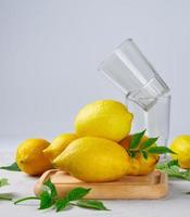 fresh ripe whole yellow lemons on a wooden board photo