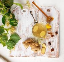 transparent cup with tea from ginger  and linden photo