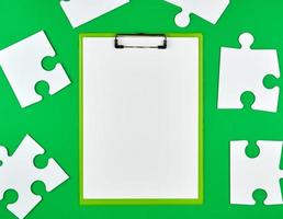 paper clip and white large paper puzzles photo