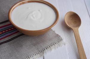sour cream in a clay bowl photo