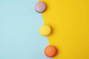 multi-colored baked round macarons on a colored background photo