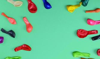 deflated balloons on a green background, copy space photo