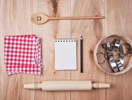 blank open notebook in line and wooden kitchen accessories, recipe concept photo