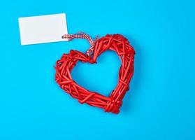 red wicker heart with paper tag on ribbon photo
