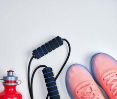 pair of pink sneakers with laces on a white background photo