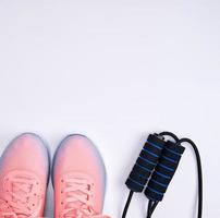 pair of pink sneakers with laces on a white background photo