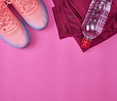 femal sports sneakers and water bottle photo