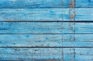 very old wooden background with blue cracked paint photo