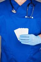 doctor  holding a blank white paper business card photo