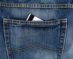 tarjeta de crédito en el bolsillo trasero de blue jeans foto