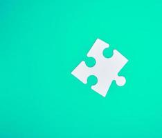 white big puzzle on a green background photo