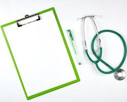 empty white sheets and  medical stethoscope on a white background photo