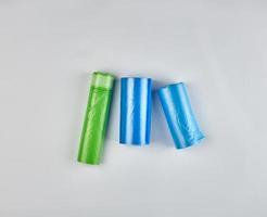 three rolled up rolls with plastic garbage bags photo