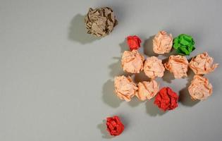 crumpled balls of paper on a gray background, top view. The concept of finding innovative ideas, the right solutions photo
