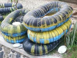 montones de neumáticos alquilados para nadar en la playa, prohibición de la playa de arena foto